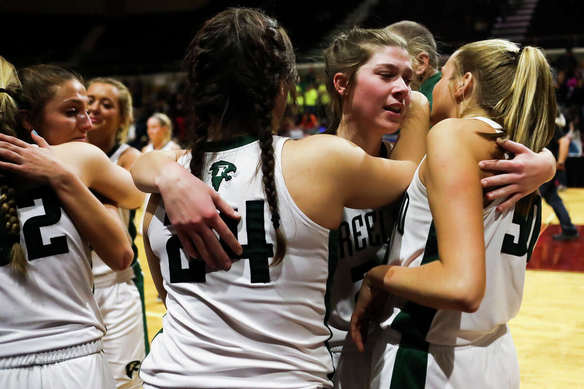 Freeland's Alyssa Argyle hugs teammates after the Falcons' 58-77 state finals loss to Detroit Edison on Saturday, March 23, 2019 at the Van Noord Arena in Grand Rapids. (Katy Kildee/kkildee@mdn.net)