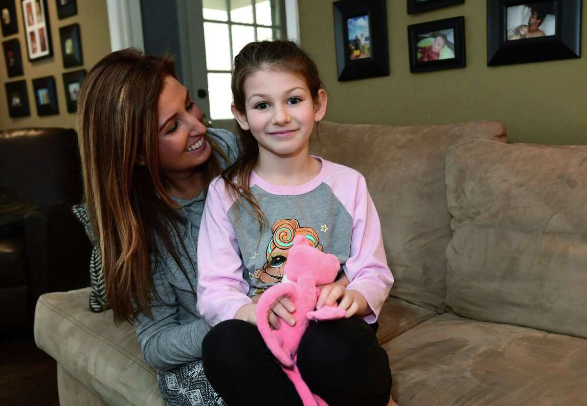 Erica DePalma, board member of the AG Bell Association for the Deaf and Hard of Hearing, with her hearing impaired daughter, Jameson DePalma, 7, at their home in Norwalk. DePalma is organizing an event for parents of children with hearing loss and their friends and families on April 17. The event, also open to professionals who treat children with hearing impairments, provides a networking opportunity for parents looking to share tips and find resources — and offers children living with disabilities the opportunity to forge friendships with each other. Childhood hearing loss is rare and some parents said they struggle to connect with families similar to theirs living in Fairfield County.