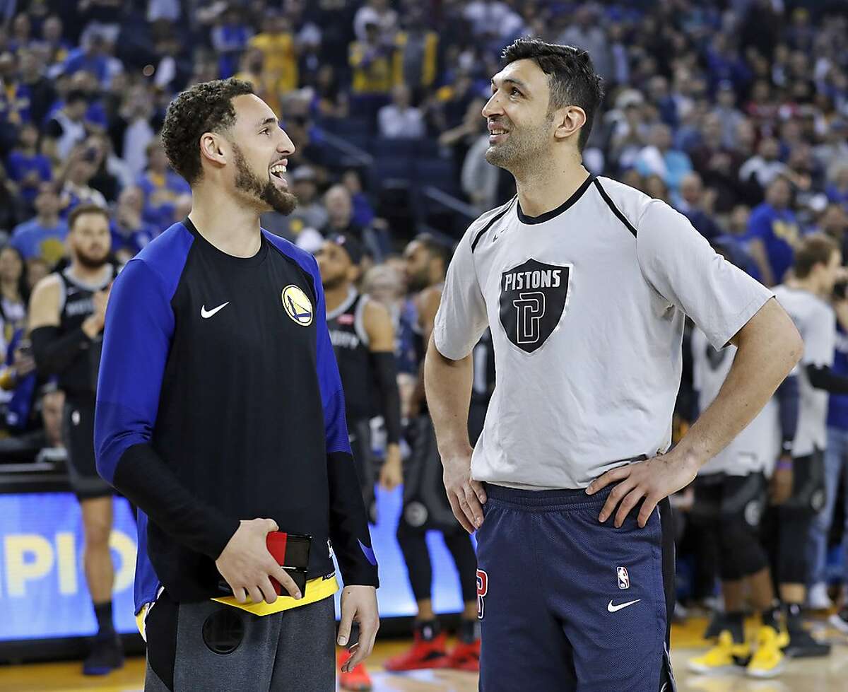 Detroit Pistons' Zaza Pachulia watches a video tribute before being presented his 2018 NBA Championship ring by Golden State Warriors' Klay Thompson before NBA game at Oracle Arena in Oakland, Calif., on Sunday, March 24, 2019.