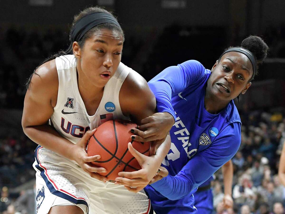 Buffalo's Brittany Morrison, right, pressures Connecticut's Megan Walker during the first half of a second-round women's college basketball game in the NCAA tournament Sunday, March 24, 2019, in Storrs, Conn. (AP Photo/Jessica Hill)