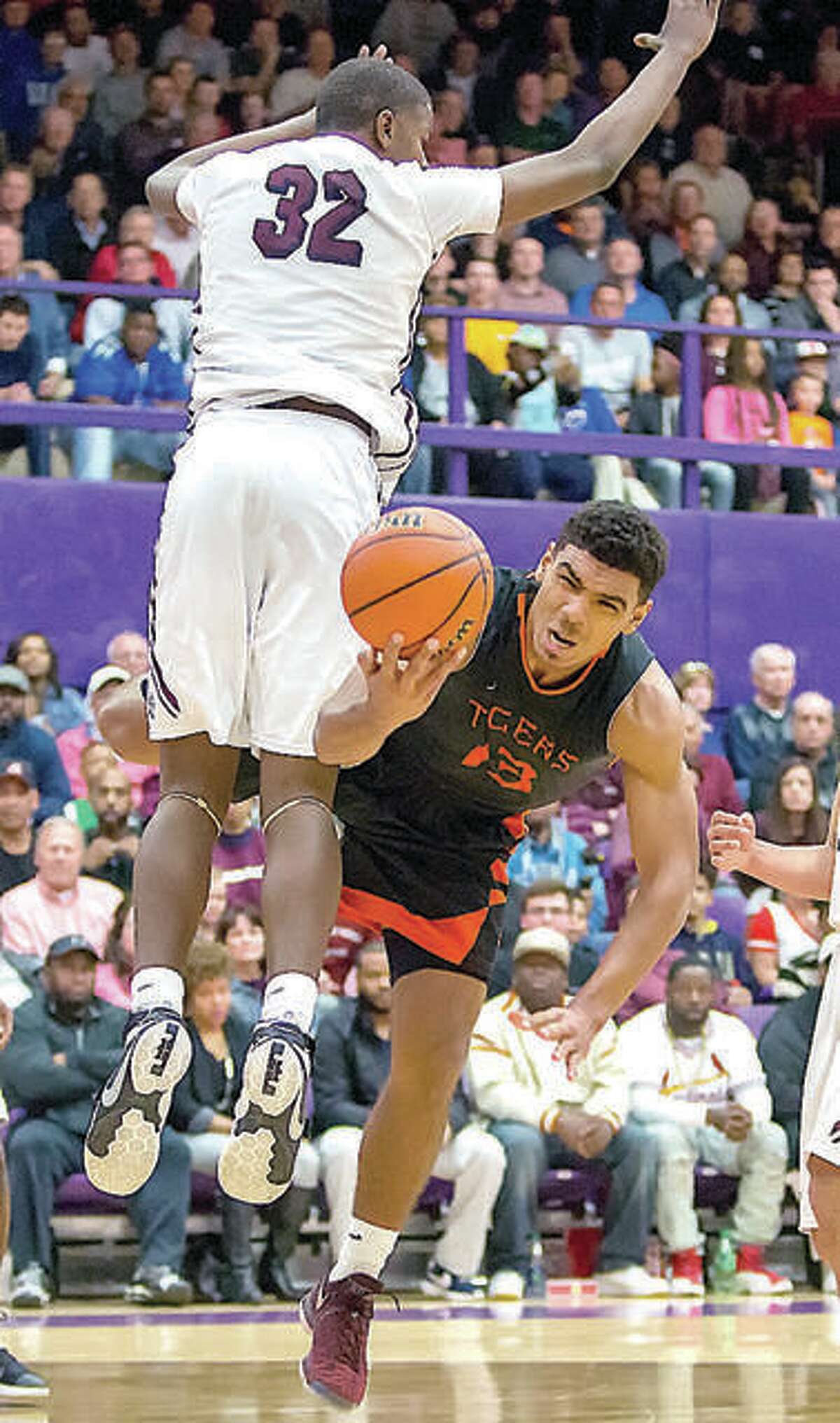 Former Edwardsville Tiger Mark Smith (13) is fouled by Belleville West forward EJ Liddell (32) during the 2017 playoffs in Collinsville. The pair, two of the state’s top prep stars of recent seasons opted for out-of-state schools, Liddell, a senior at West, chose Ohio State in October and Smith is at Missouri, after transferring following his freshman season at Illinois.