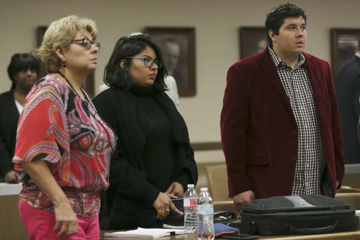 Joe Martinez, 27, right, and his sister, Brittany Martinez, 25, stand with their mother, Laura Martinez, 54, as Bexar County 73rd District Court Judge David Canales enters the courtroom during an adoption hearing, Tuesday, March 19, 2019. The guardians of incapacitated Charlie Thrash, 81, took the siblings to court to have their adoptions by the elder Thrash nullified. Their mother married Thrush in five-minute ceremony on March 4th and the next day he adopted her adult children. Last Friday, Judge Oscar Kazen annulled the marriage. During the adoption hearing, Canales ruled in favor of the guardians and nullified the adoptions.