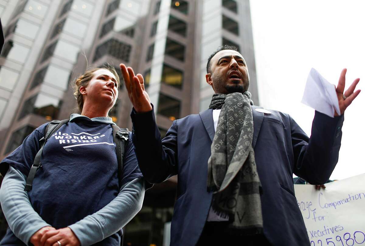 Omar Alkhameri (right) speaks to a group of Lyft drivers to kick off a protest against Lyft's paycuts as well as the company going public on Friday in San Francisco , California, on Monday, March 25, 2019. Drivers argue that their share has been cut significantly and that they are the backbone of the company.