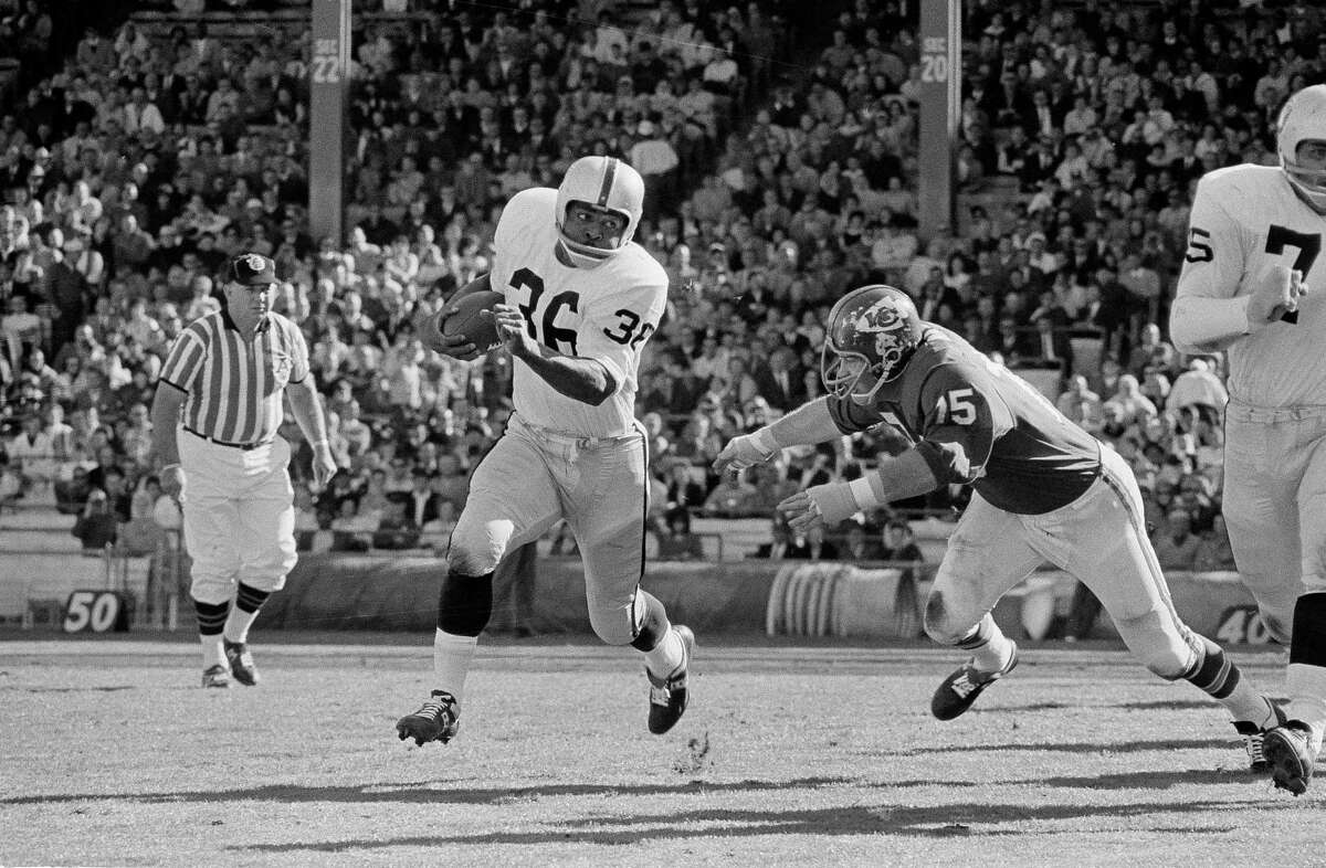In 1965, Clem Daniels of the Oakland Raiders scampers past Jerry Mays of the Chiefs in Kansas City.