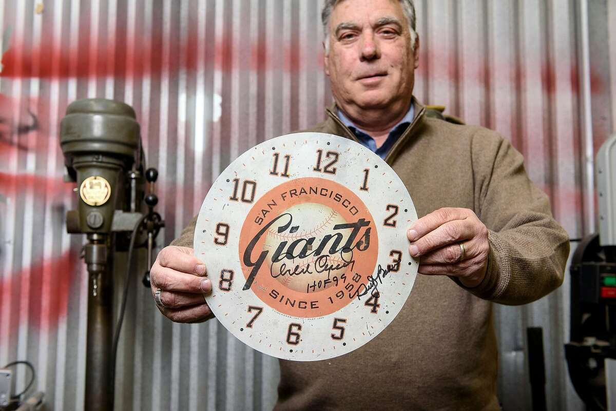 Designer Steve Kowalski holds the face plate of a clock signed by Orlando Cepeda that matches the design of a clock he sent to Giant's managing general partner Peter McGowan which landed his company Timeworks the contract to design a scoreboard clock for the teams new stadium AT&T Park, in Richmond, Calif., on Tuesday, February 5, 2019. Steve Kowalski and his company Timeworks designed the 20 foot tall clock that has resided in the San Francisco Giants outfield scoreboard since the opening of the ballpark in 2000, but is now being removed as a new screen and scoreboard is installed for the 2019 season.
