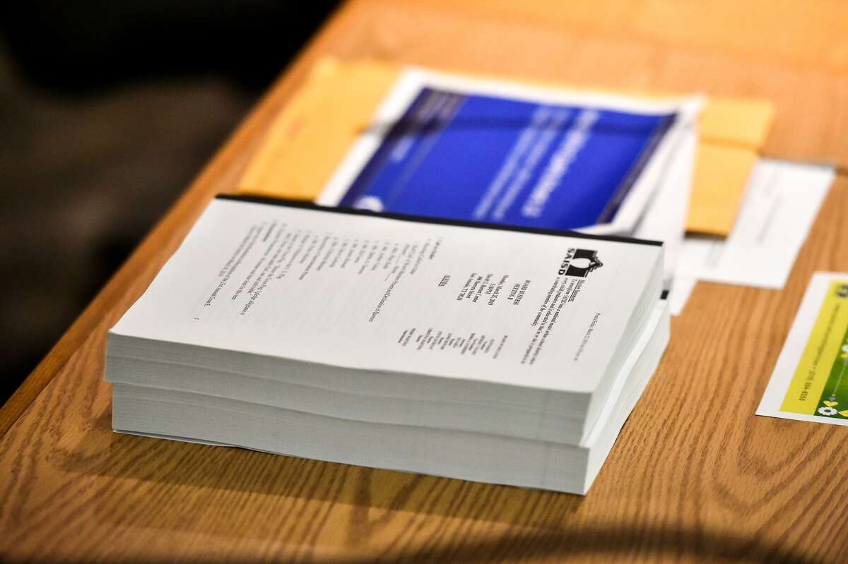 A copy of a 1,200-page agenda sits on the SAISD desk Monday prior to the board meeting. All the schools will be run “in collaboration with” SAISD, according to the management agreements.