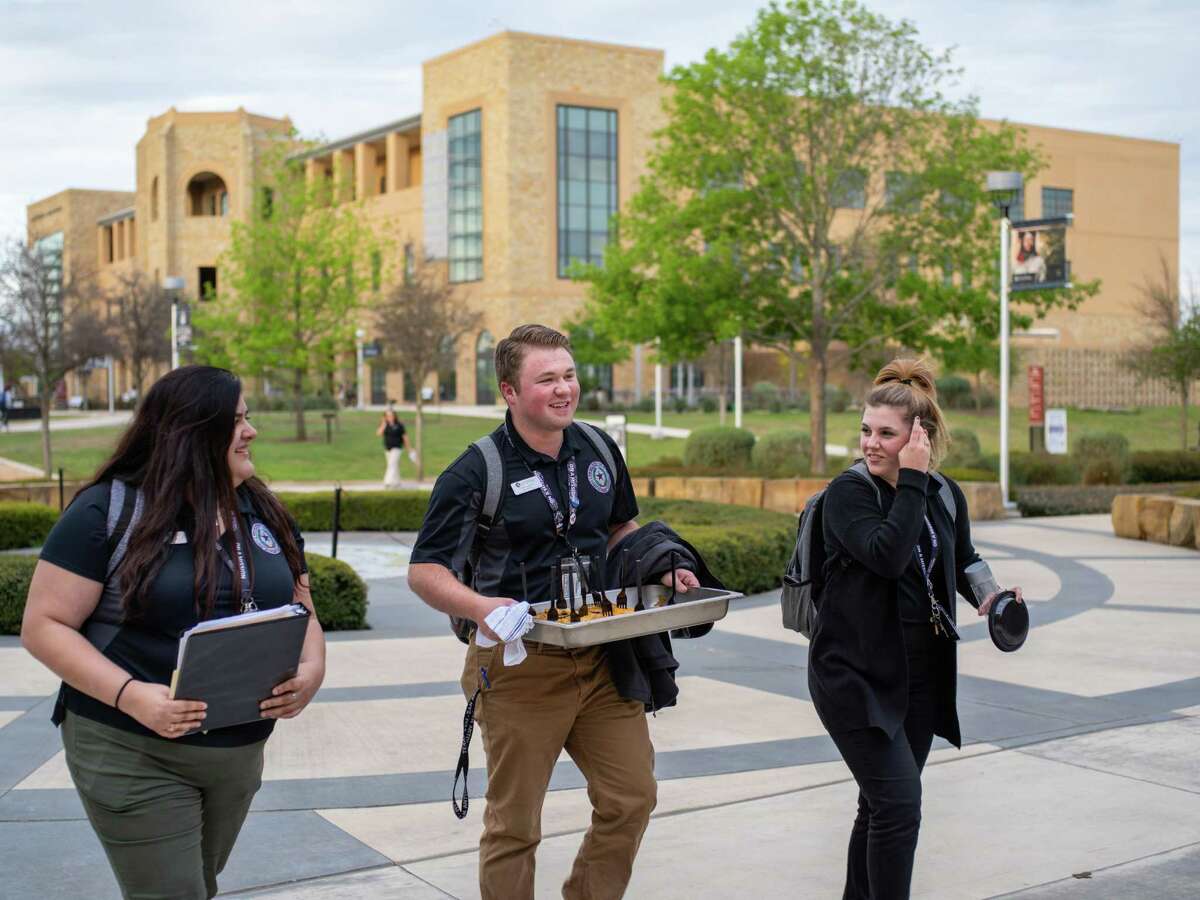 From left, Student Government Association members Emily Marquise, Clayton Jaskinia, and Marissa Lyssy walk through campus after a Student Government Association meeting at Texas A&M University San Antonio on Monday, March 18, 2019.
