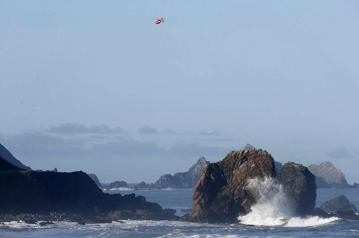 A Coast Guard helicopter flies above Rockaway Beach searching for a swimmer who was reported missing in the early morning hours in Pacifica, Calif. on Tuesday, March 26, 2019.
