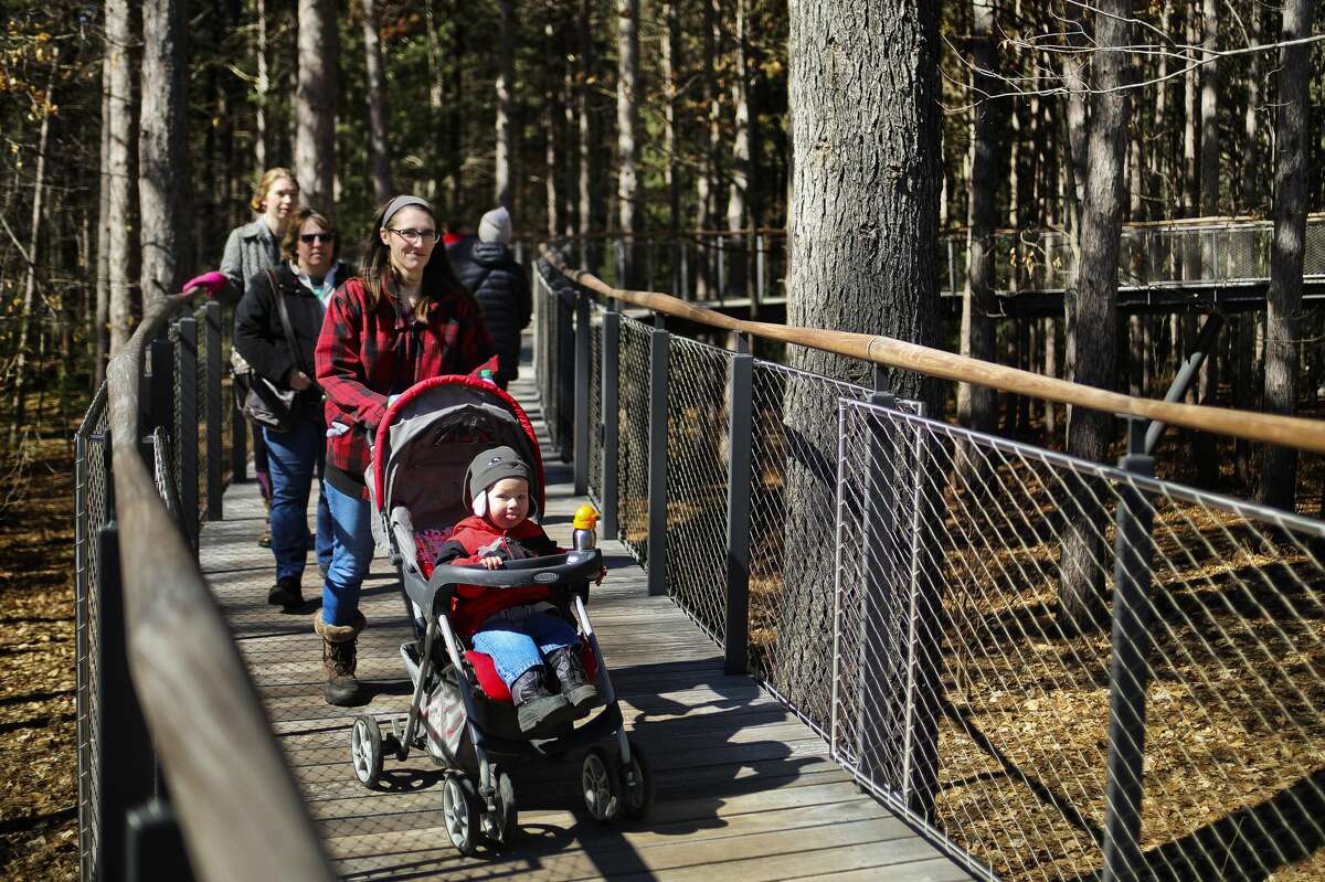 Taylor Crane of Midland pushes her son Sam, 1, in his stroller during a visit to the Whiting Forest Canopy Walk on Tuesday, March 26, 2019 in Midland. (Katy Kildee/kkildee@mdn.net)