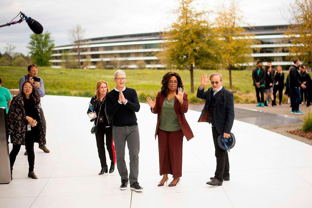 Apple CEO Tim Cook (L), Oprah Winfrey (C) and director Steven Spielberg stand for a photo during an event launching Apple tv+ at Apple headquarters on March 25, 2019, in Cupertino, California. (Photo by NOAH BERGER / AFP)NOAH BERGER/AFP/Getty Images
