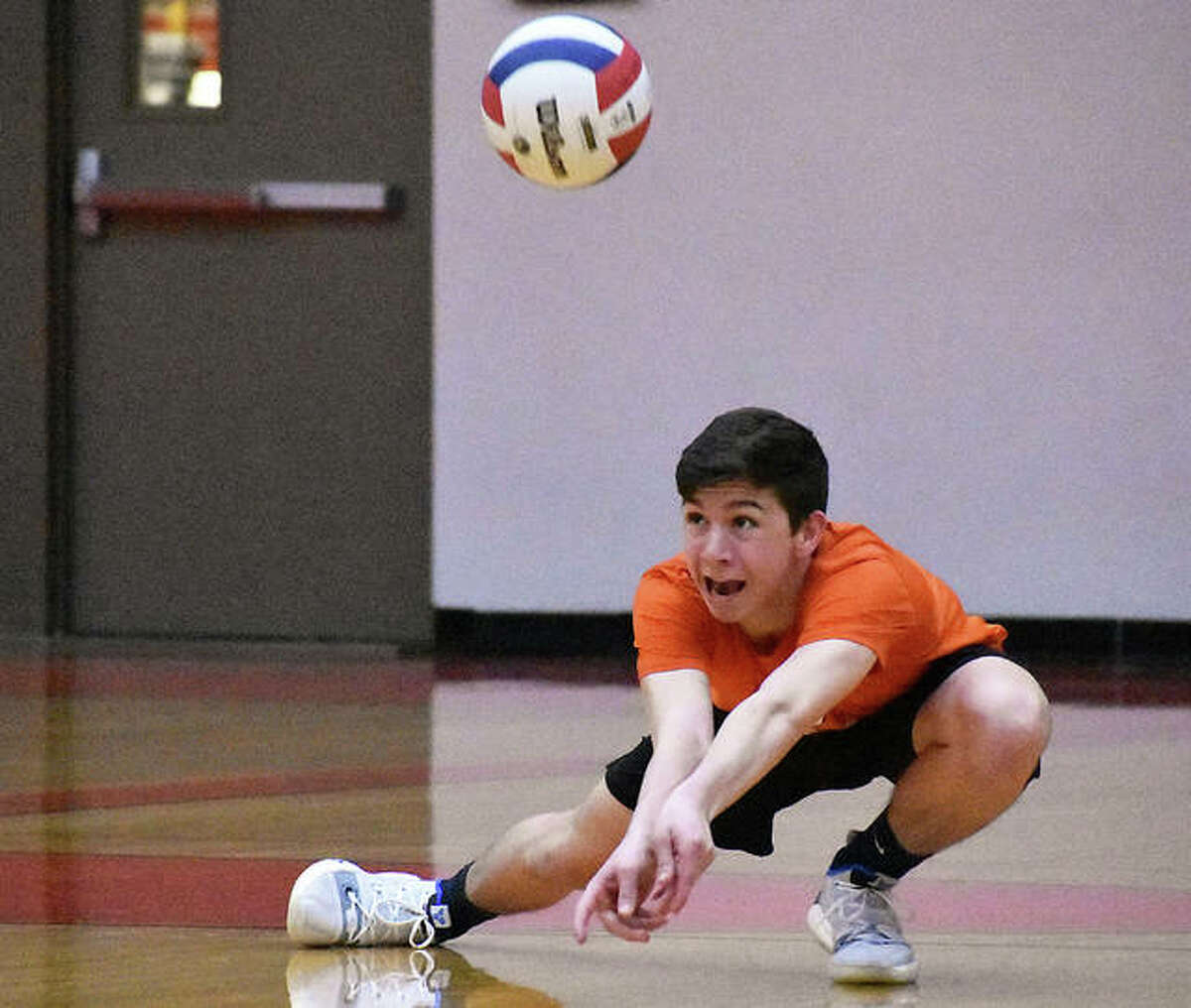 Edwardsville libero Henry Hupp successfully makes a dig during the second game against Belleville East.