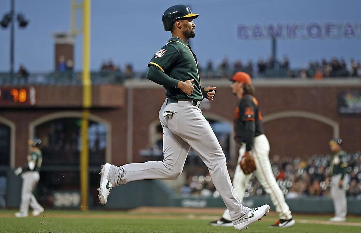 Oakland Athletics' Marcus Semien scores on Nick Hundley's 2nd inning sacrifice fly off of San Francisco Giants' Jeff Samardzija in Bay Bridge Series game at Oracle Park in San Francisco, Calif., on Tuesday, March 26, 2019.