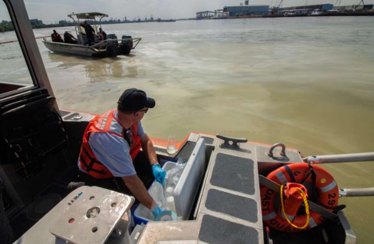 Members of the Texas Commission on Environmental Quality collect water samples from the affected area of the Houston Ship Channel near La Porte, Texas, on March 20, 2019.