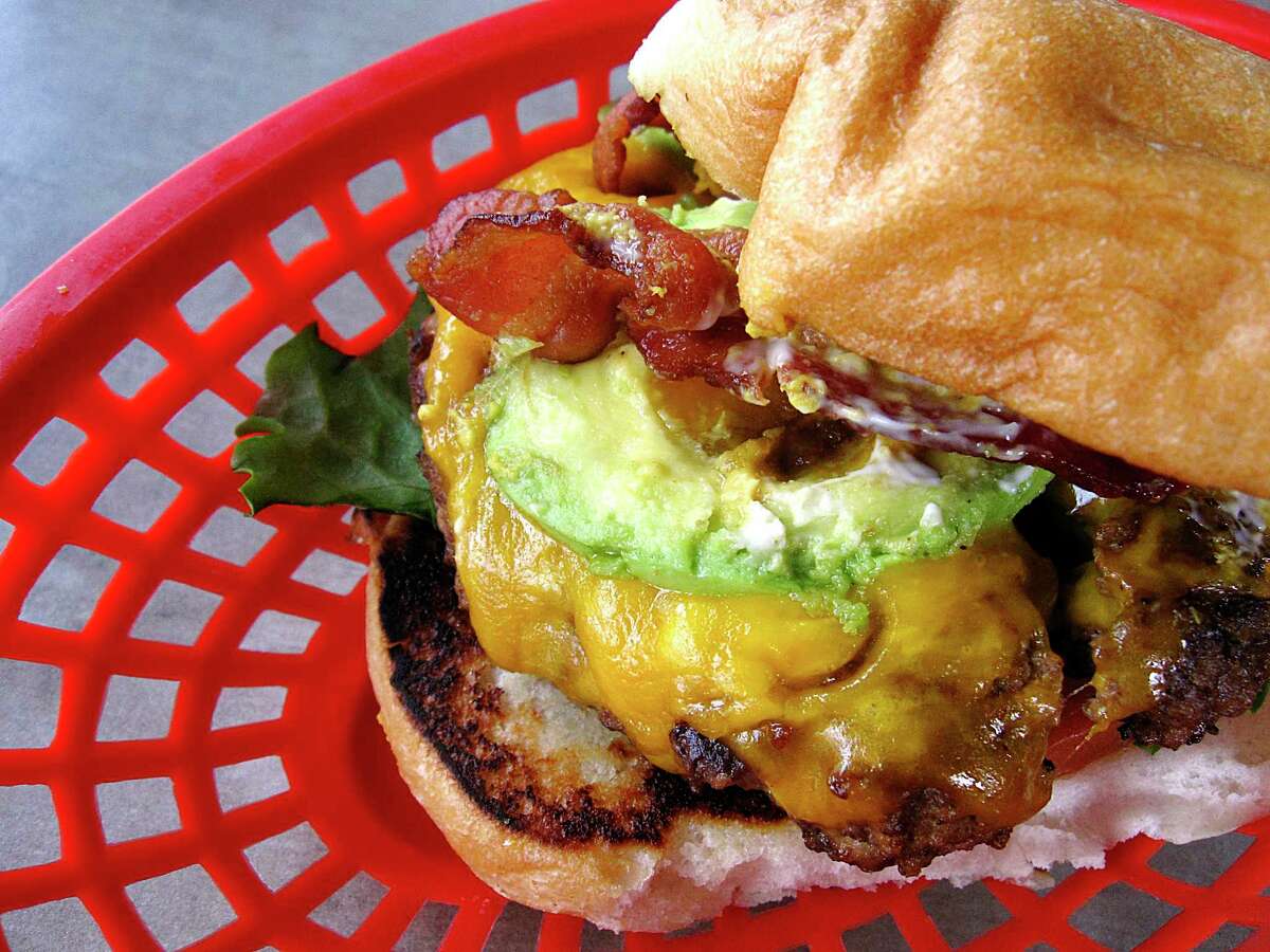 Mark’s Outing is participating in Black Restaurant Week San Antonio Feb. 21-28. Pictured is its Heisman Burger is served with cheese, bacon, avocado, lettuce, tomato, onions and pickles.