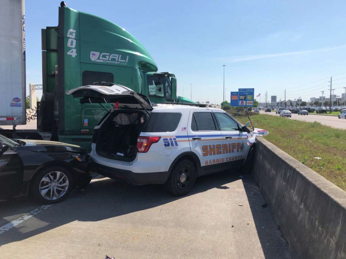 A Harris County Sheriff's Office patrol car was crushed after a crash with an 18-wheeler on Katy Freeway near Mason Road on Wednesday, March 27, 2019.