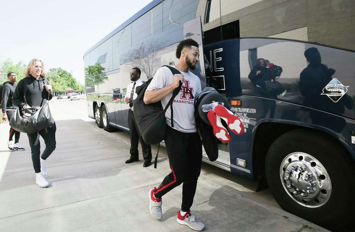 Houston Cougars guard Galen Robinson Jr. , from right, gets onto the team bus along with teammates Landon Goesling and Fabian White Jr. as they get ready to head to Kansas City for the Sweet 16 on Wednesday, March 27, 2019.