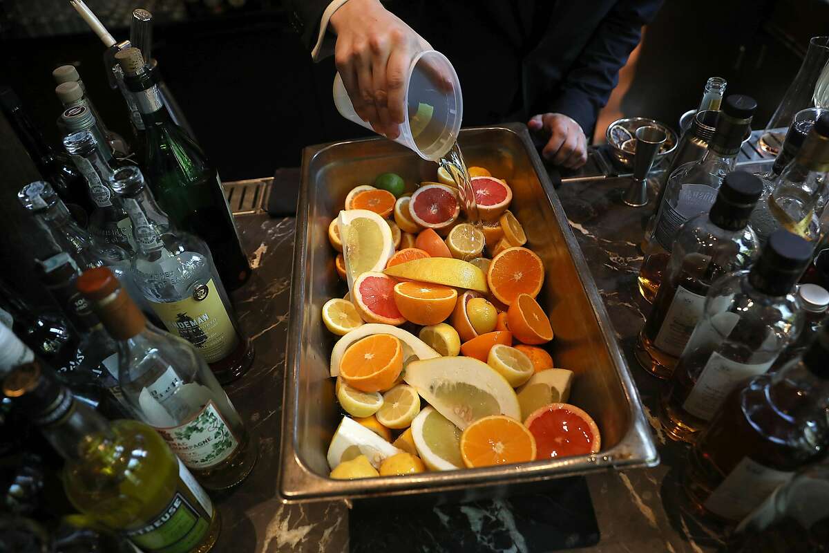 Head bartender Michael Kudra seasons his fruit before marmalading at Quince on Monday, March 18, 2019, in San Francisco, Calif.