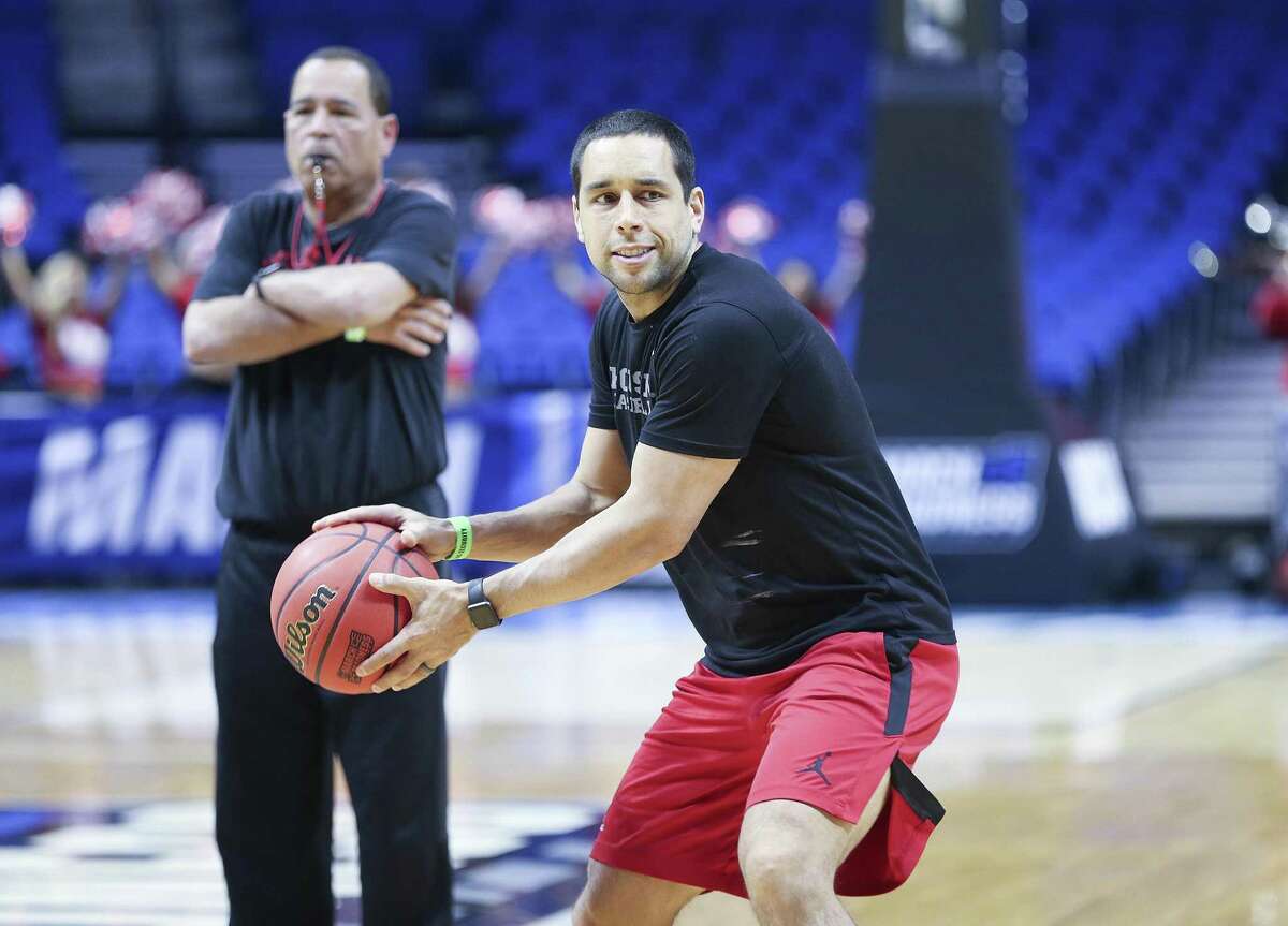 Houston Cougars assistant coach Kellen Sampson goes through drills with the team under the watchful eye of his dad and head coach Kelvin Samspon last week in Tulsa.