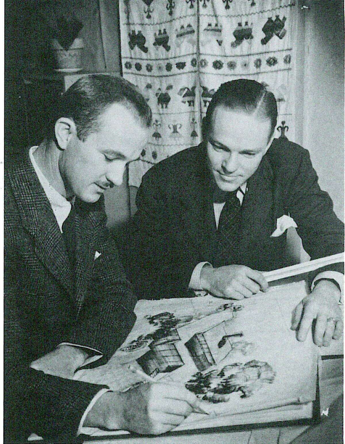 Partners O’Neil Ford (left) and A.B. Swank discuss a perspective drawing of a frame house.