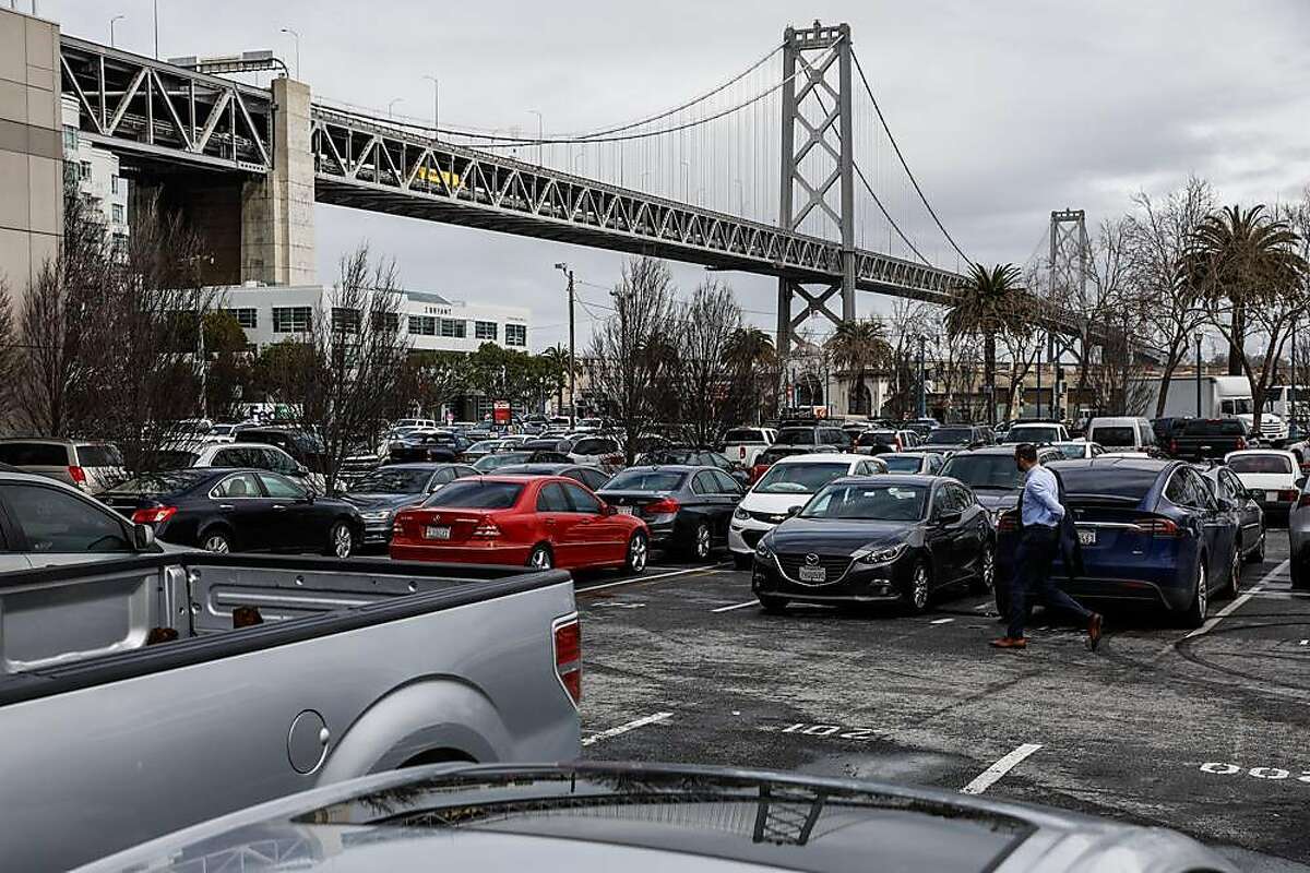 A man walks through a parking lot near the Embarcadero in San Francisco, California, on Wednesday, March 27, 2019. The parking lot had been proposed by Mayor London Breed as a potential Navigation Center.