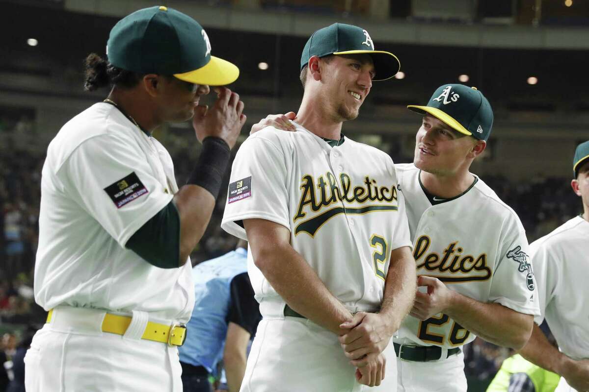 Khris Davis #2, Stephen Piscotty#25, and Matt Chapman #26 of the Oakland Athletics joke prior to the 2019 Opening Series at the Tokyo Dome on Wednesday, March 20, 2019 in Tokyo, Japan.
