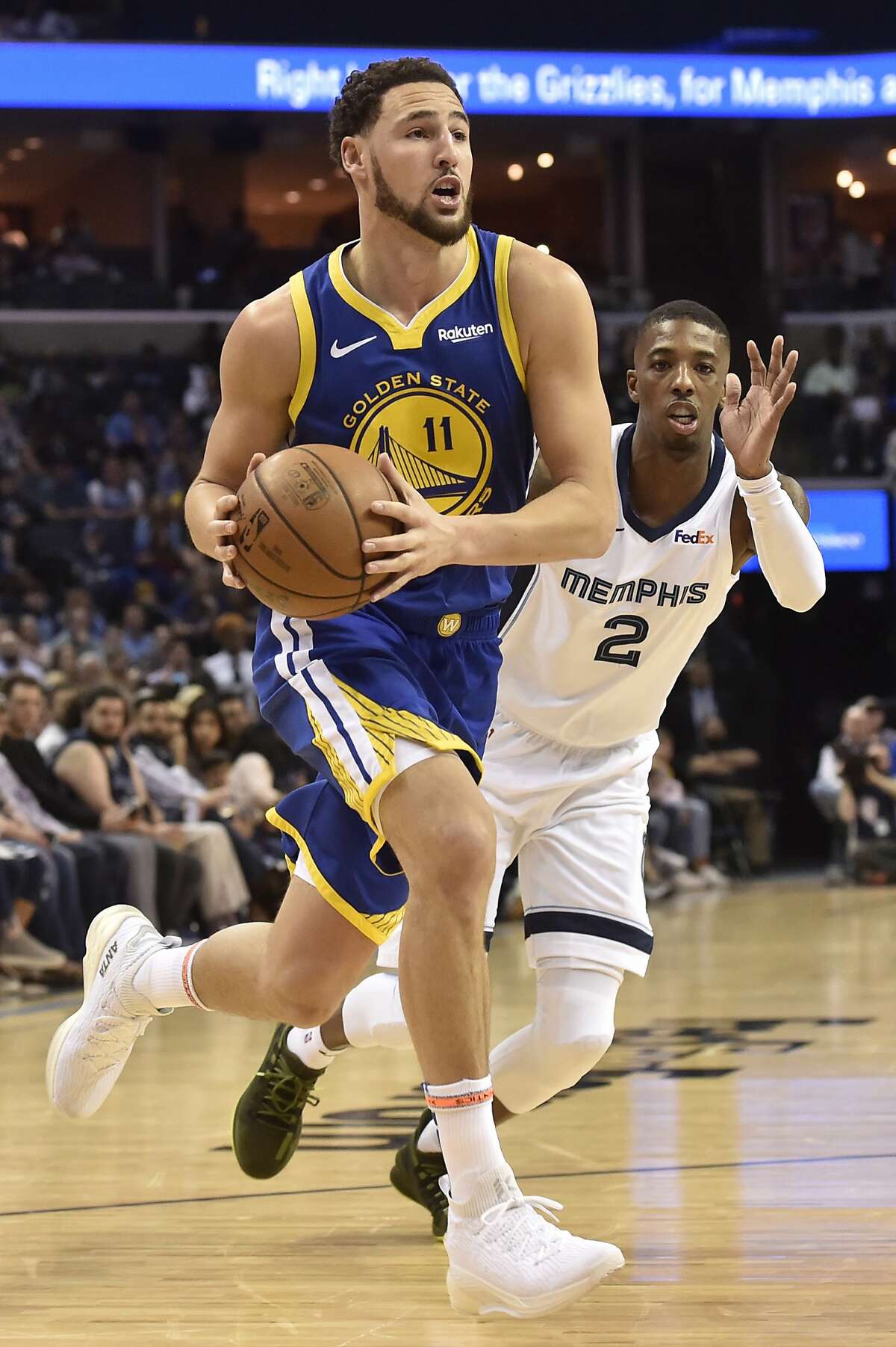 Golden State Warriors guard Klay Thompson (11) drives next to Memphis Grizzlies guard Delon Wright (2) during the second half of an NBA basketball game Wednesday, March 27, 2019, in Memphis, Tenn. (AP Photo/Brandon Dill)