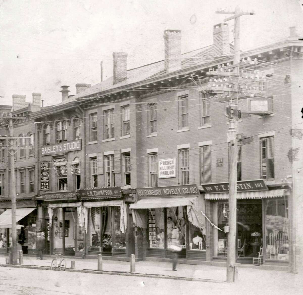 This stretch of Main Street in Danbury was referred to as The Thompson Block. On the second floor of 197 Main, notice Baisley Studios. Frank Henry Baisley was a hatter in his younger life before getting into the photography trade. He had a studio in New Rochelle, NY before he came to Danbury to conduct business.