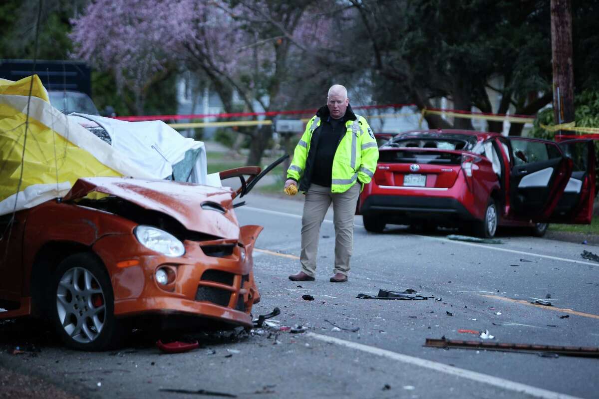 An investigator looks at the scene of a collision in which one driver was killed in the 1700 block of Sand Point Way Northeast, Wednesday, March 27, 2019.