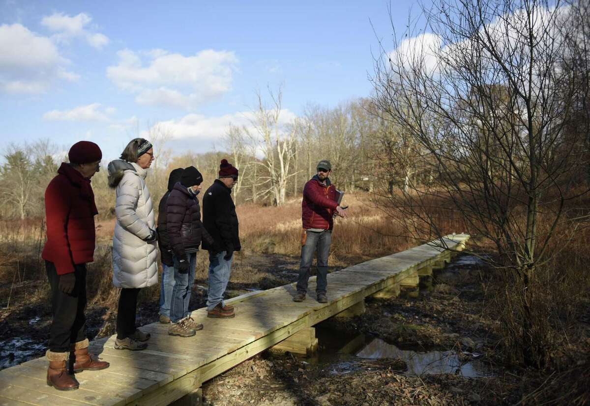 Greenwich Land Trust Conservation & Outreach Director Steve Conaway, Ph.D., identifies a willow tree during the Winter Walk at Greenwich Land Trust's Lapham Preserve in Greenwich, Conn. Tuesday, Dec. 11, 2018. Folks learned how to identify leafless trees by learning the diverse features of bark, branches, and buds, as well as tactics employed by flora and fauna to survive the cold winter months.