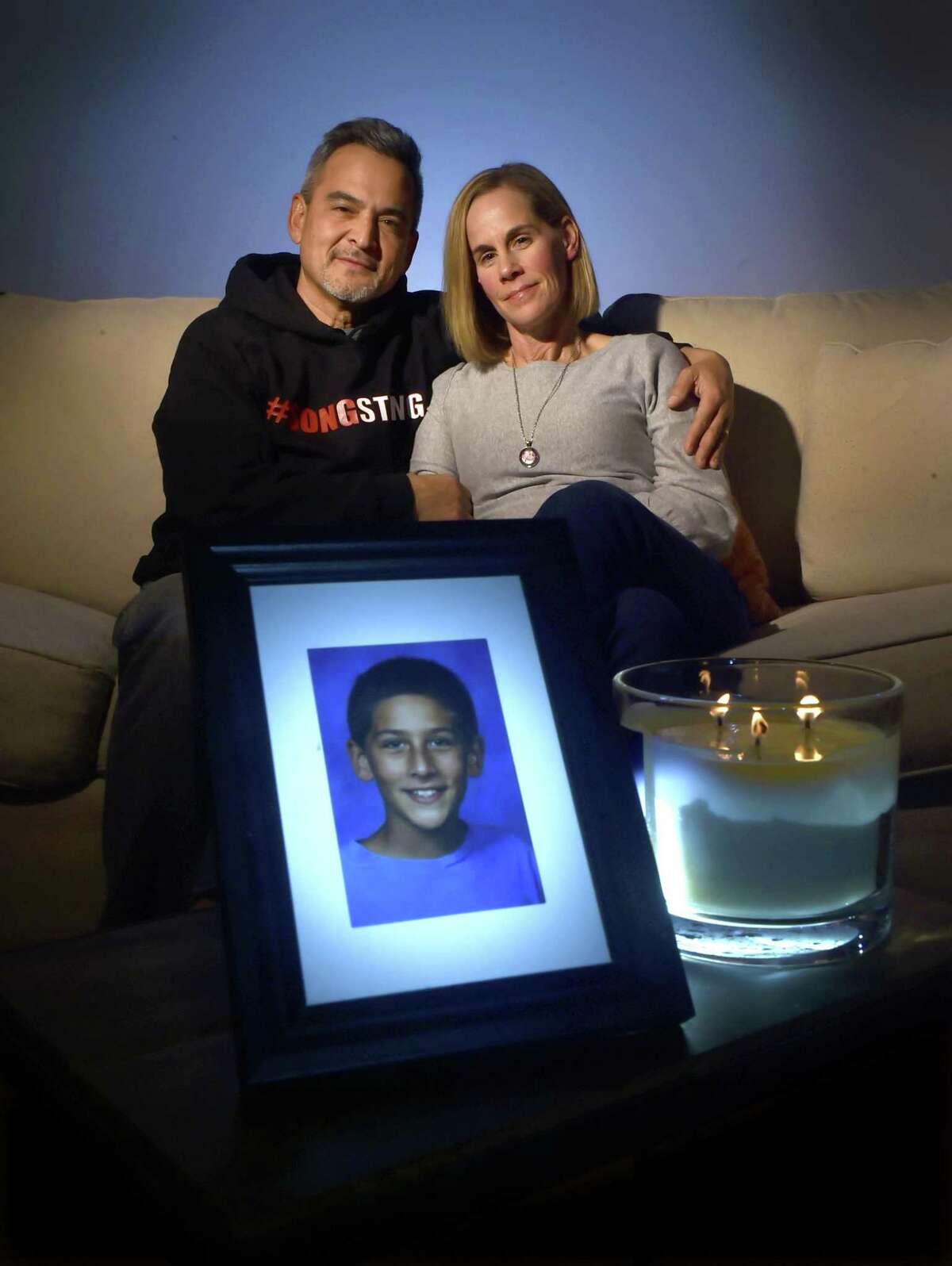 Mike and Kristin Song, of Guilford, in their home last November. Their son, Ethan, shot himself to death accidentally.