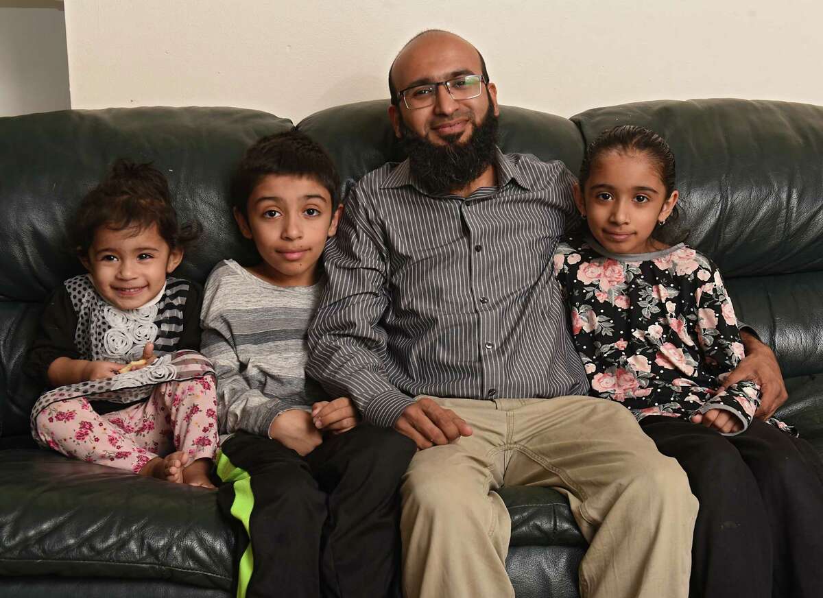 Sajid Memon sits with his children, from left, Zainab, 1 1/2, Shaheer, 10, and Alishba, 8, at his home on Wednesday, March 27, 2019 in Albany, N.Y. He has family who still lives in the Beira Mozambique area which was wiped out by a devastating cyclone more than a week ago with a death toll rising to at least 750. (Lori Van Buren/Times Union)