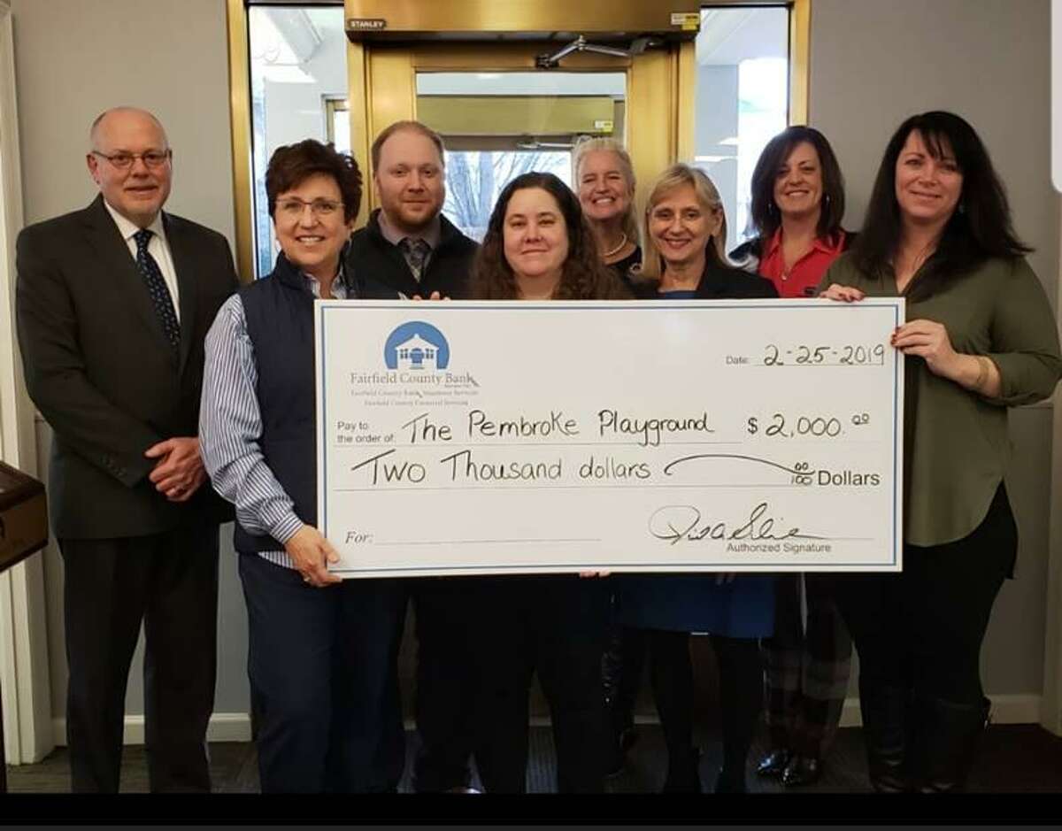 Fairfield County Bank presents a $2,000 check to The Pembroke Playground Project.