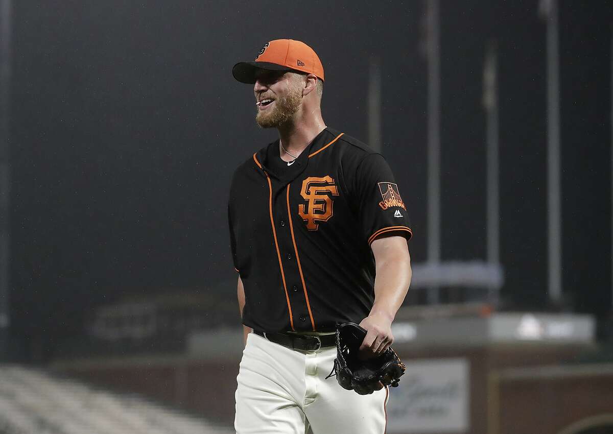 San Francisco Giants relief pitcher Will Smith smile as he walks to the dugout after the last out of the top of the fifth inning of an exhibition baseball game against the Oakland Athletics in San Francisco, Monday, March 25, 2019. (AP Photo/Jeff Chiu)