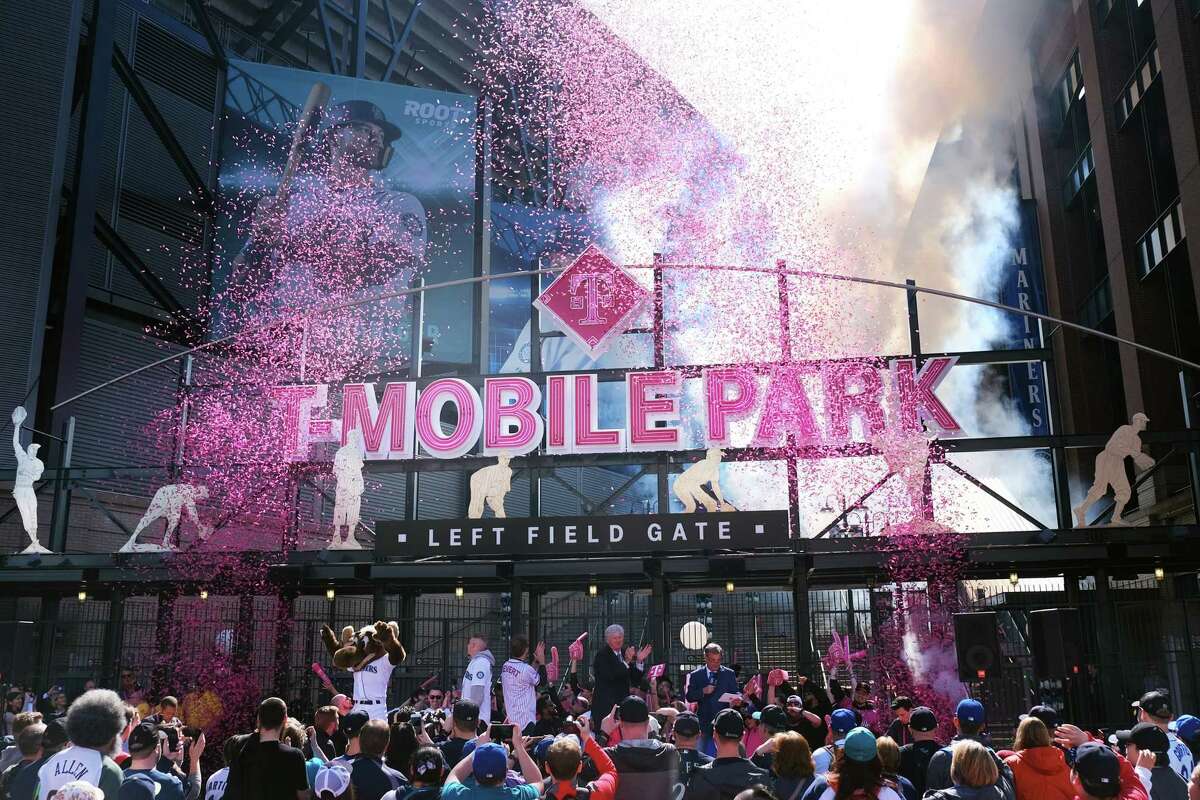 Dignitaries, including Mariners Chairman John Stanton, Rick Rizzs and hip-hop artist Macklemore, lead the gate opening ceremony of the newly renamed T-Mobile Park before the Mariners season home opener against the Red Sox, Thursday, March 28, 2019.