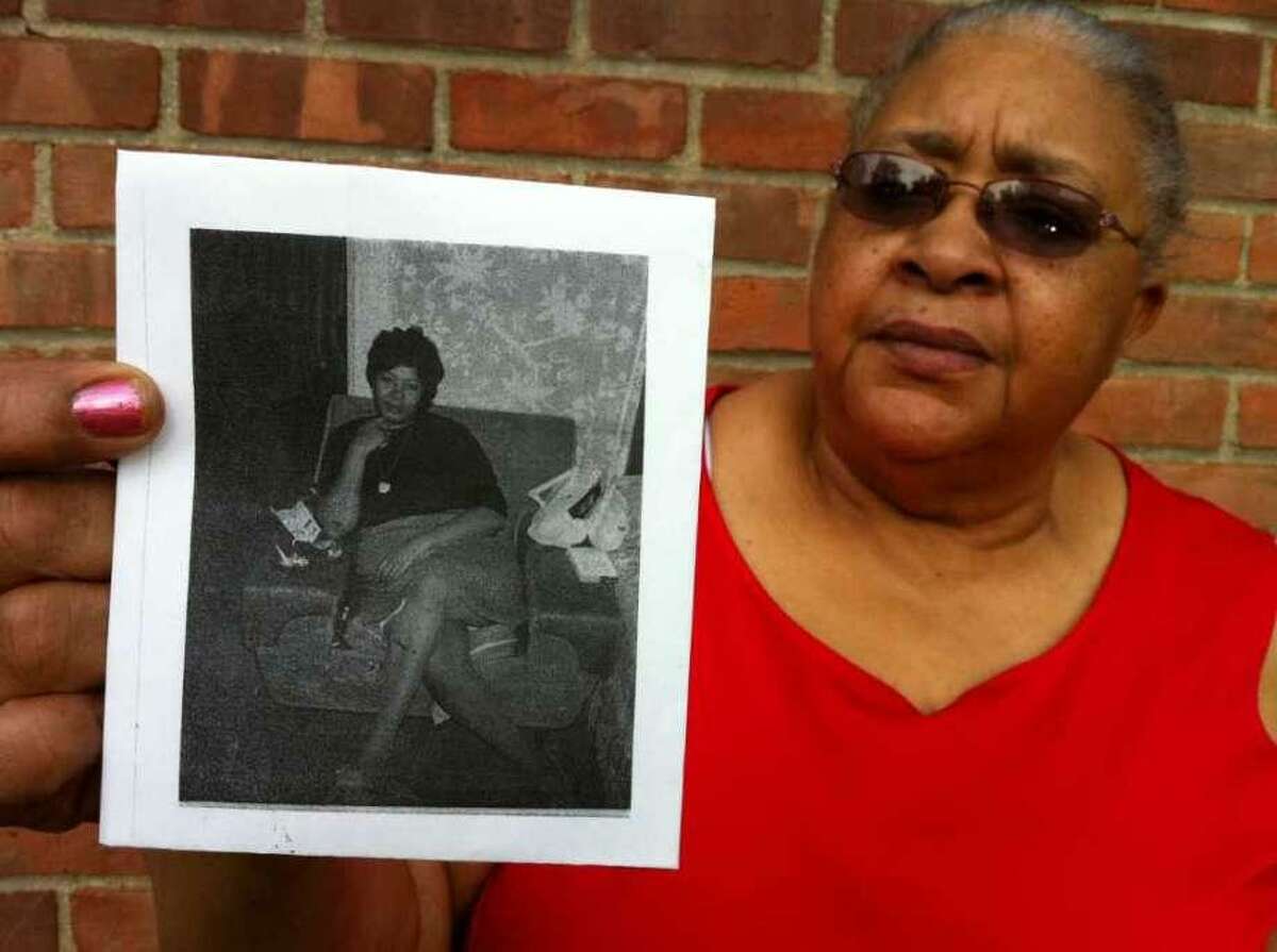 Stamford resident Earlean Hines holds a photograph of her sister Carrie Lee Mock, also of Stamford, who was found murdered in Greenwich on July 19, 1981.