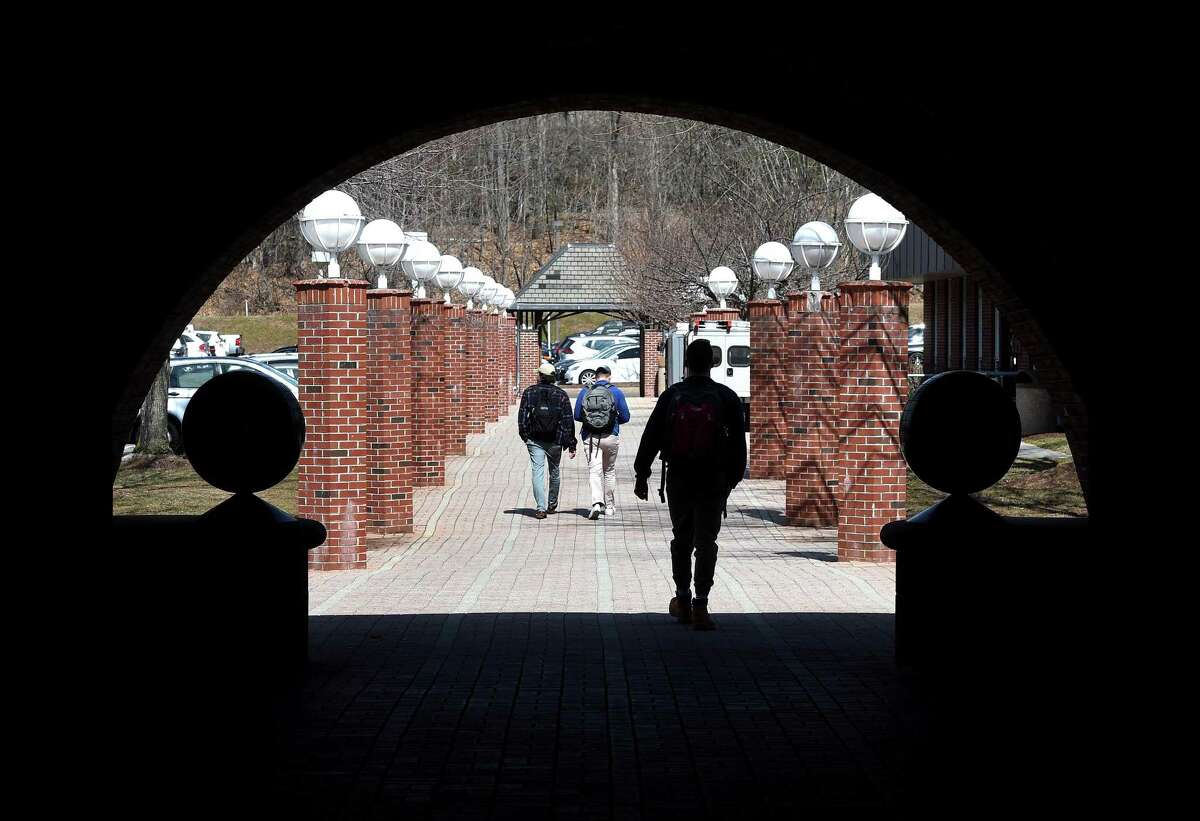 Students walk from the Lender School of Business Center to the parking lot at Quinnipiac University in Hamden on March 28, 2019.