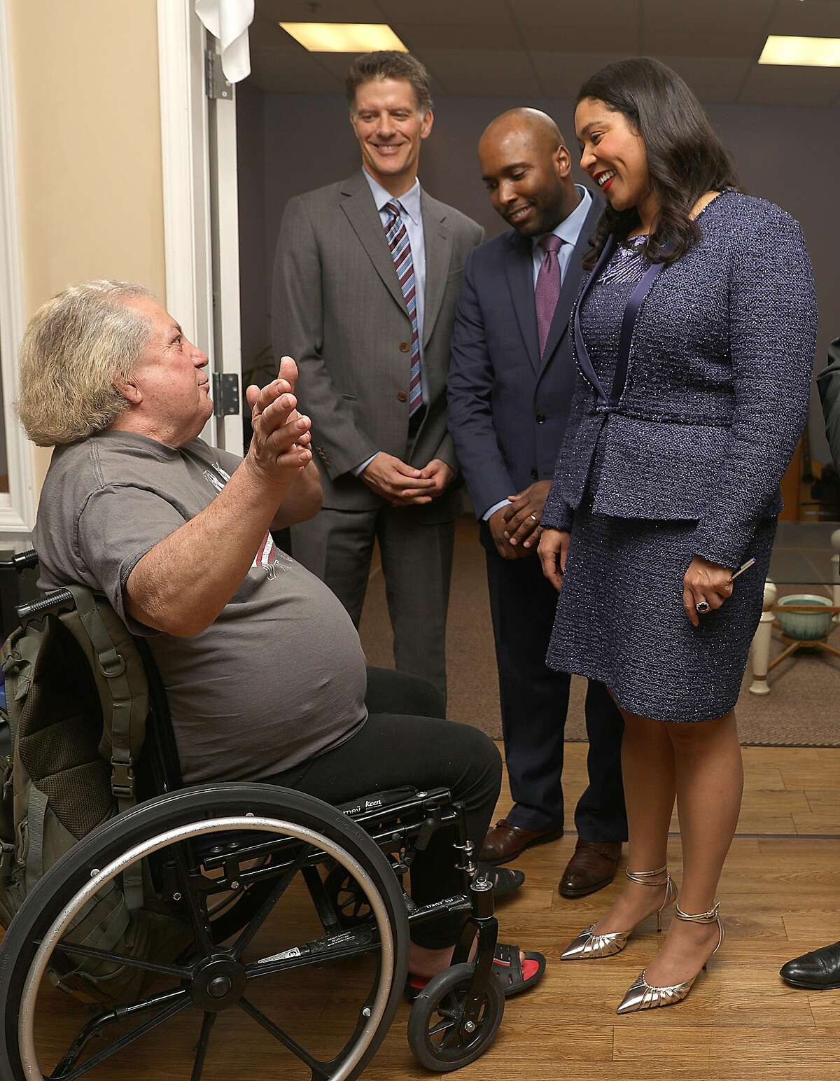 Mayor London Breed (right) appoints Dr. Anton Nigusse Bland (middle right) director of mental health reform and develop a substance use treatment for homeless clients announced at Dore Urgent Care center as they talk with patient Lucio diMauro (left) on Wednesday, March 27, 2019, in San Francisco, Calif. Dr. Grant Cofax (middle left) has recently become San Francisco's director of Health.