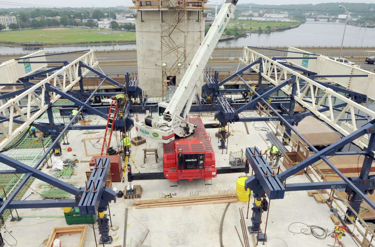 Carpenter Sean Nolan, clipped into the ironwork Form Traveler atop of the "New" Q-Bridge. The Form Traveler, shown during the construction phase in rear of the photo, rests on the Pier Table which is required for construction of the Segmental Box Superstructure. Specialized concrete will then be poured into the form created by the construction workers using the Form Traveler which will eventually be the Extradosed Cable Stayed Bridge that will be the new Pearl Harbor Memorial Bridge. Photo by Peter Hvizdak / New Haven Register July 8, 2011 ph2321 #8699 Connecticut