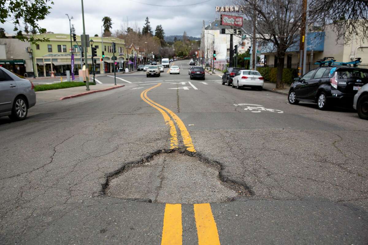 Potholes are seen on Park Blvd in Oakland, Calif. on Thursday, March 28, 2019.