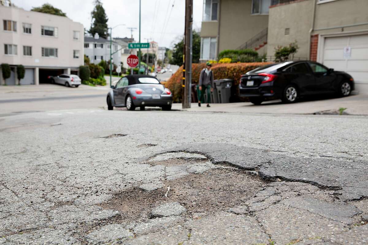 Potholes are seen on Park Blvd in Oakland, Calif. on Thursday, March 28, 2019.