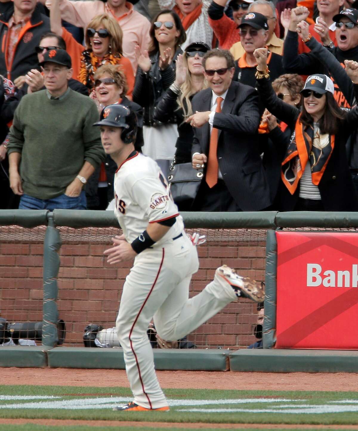 Larry Baer smiles as Giants Buster Posey scored in the first inning on a Hunter Pence double during Game 3 of the NLCS at AT&T Park on Tuesday, Oct. 14, 2014 in San Francisco, Calif.