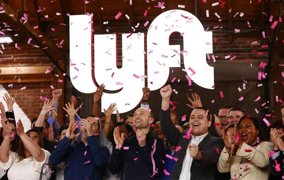 LOS ANGELES, CA - MARCH 29: Confetti falls as Lyft CEO Logan Green (C) and President John Zimmer (LEFT C) ring the Nasdaq opening bell celebrating the company's initial public offering (IPO) on March 29, 2019 in Los Angeles, California. The ride hailing app company's shares were initially priced at $72. (Photo by Mario Tama/Getty Images) *** BESTPIX ***