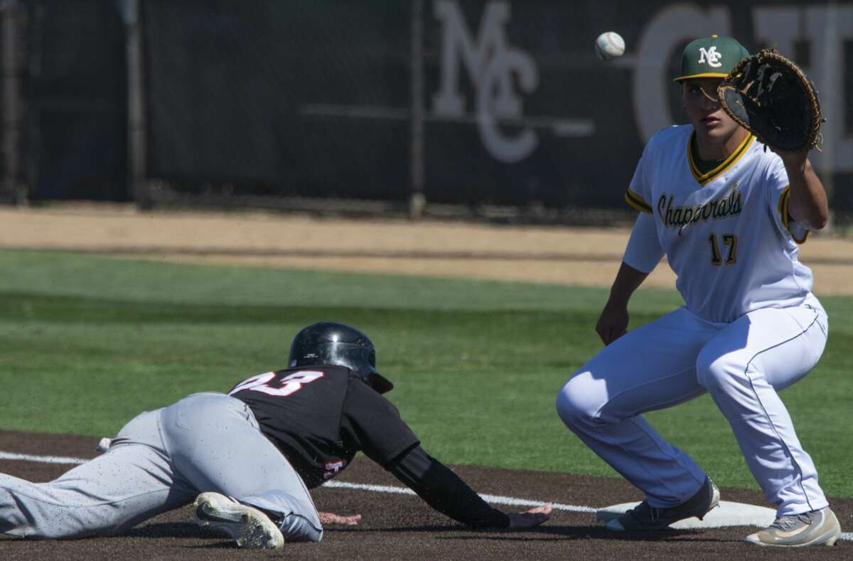 Midland College's Randy Huerta reaches for the ball on a pick-off attempt as Howard College's Trace Bucey dives back to first 03/29/19 at Christensen Stadium. Tim Fischer/Reporter-Telegram