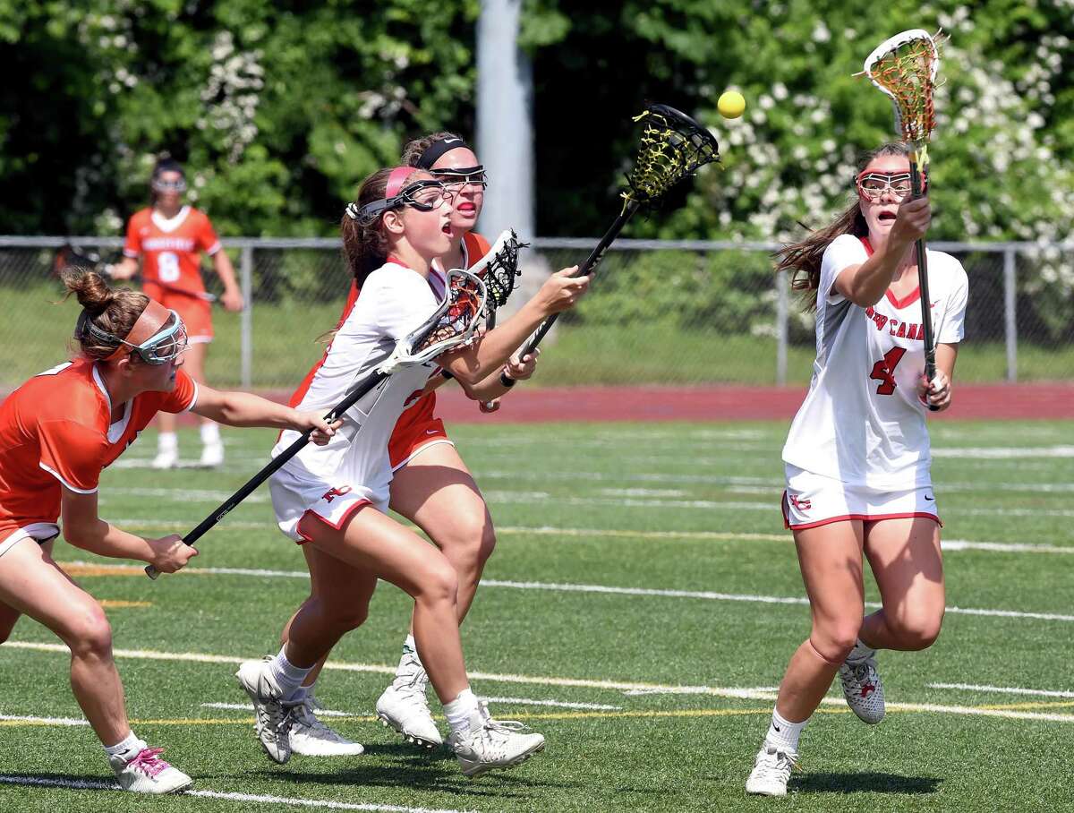 Ridgefield and New Canaan fight for possession of the ball in the first half of the CIAC Class L Girls Lacrosse Finals at Jonathan Law High School in Milford on June 9, 2018. Left to right are Caitlin Slaminko of Ridgefield, McKenna Harden of New Canaan, Caroline Curnal of Ridgefield and Kendall Patten of New Canaan.