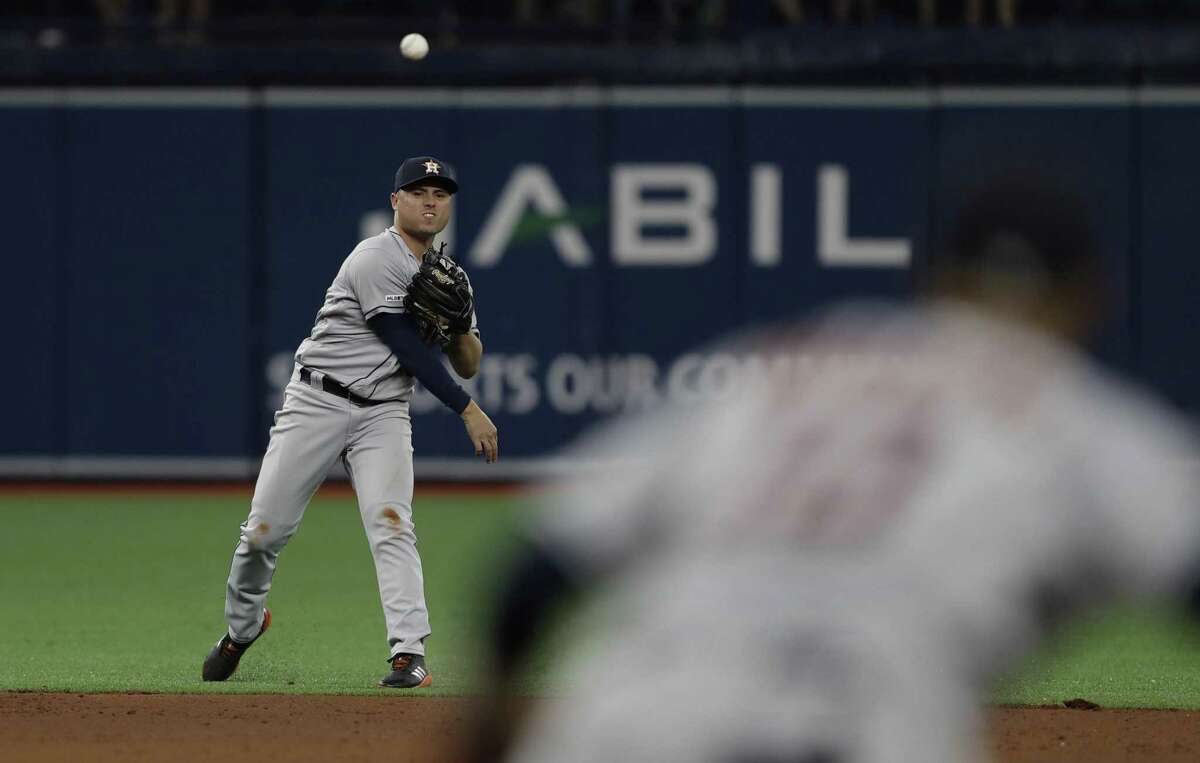 Houston Astros shortstop Aledmys Diaz makes a throwing error allowing Tampa Bay Rays' Tommy Pham to reach safely during the sixth inning of a baseball game Friday, March 29, 2019, in St. Petersburg, Fla. (AP Photo/Chris O'Meara)