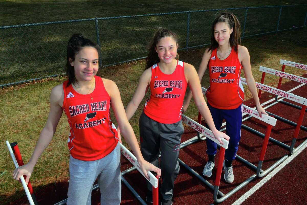 Sisters Aliya Cameron, Kayla Cameron and Meaghan Cameron pose at Sacred Heart Academy in Hamden, Conn., on Wednesday, Mar. 27, 2019. All three are on the girls outdoor track team. Each girl has their expertise - Aliya does the triple jump, Kayla does the pole vault and 100 hurdles and Meaghan excels in the 400.