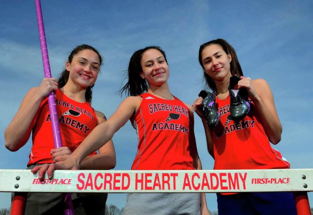 Sisters Kayla Cameron, left, Aliya Cameron, center, and Meaghan Cameron pose at Sacred Heart Academy in Hamden, Conn., on Wednesday, Mar. 27, 2019. All three are on the girls outdoor track team. Each girl has their expertise - Kayla does the pole vault and 100 hurdles, Aliya does the triple jump and Meaghan excels in the 400.