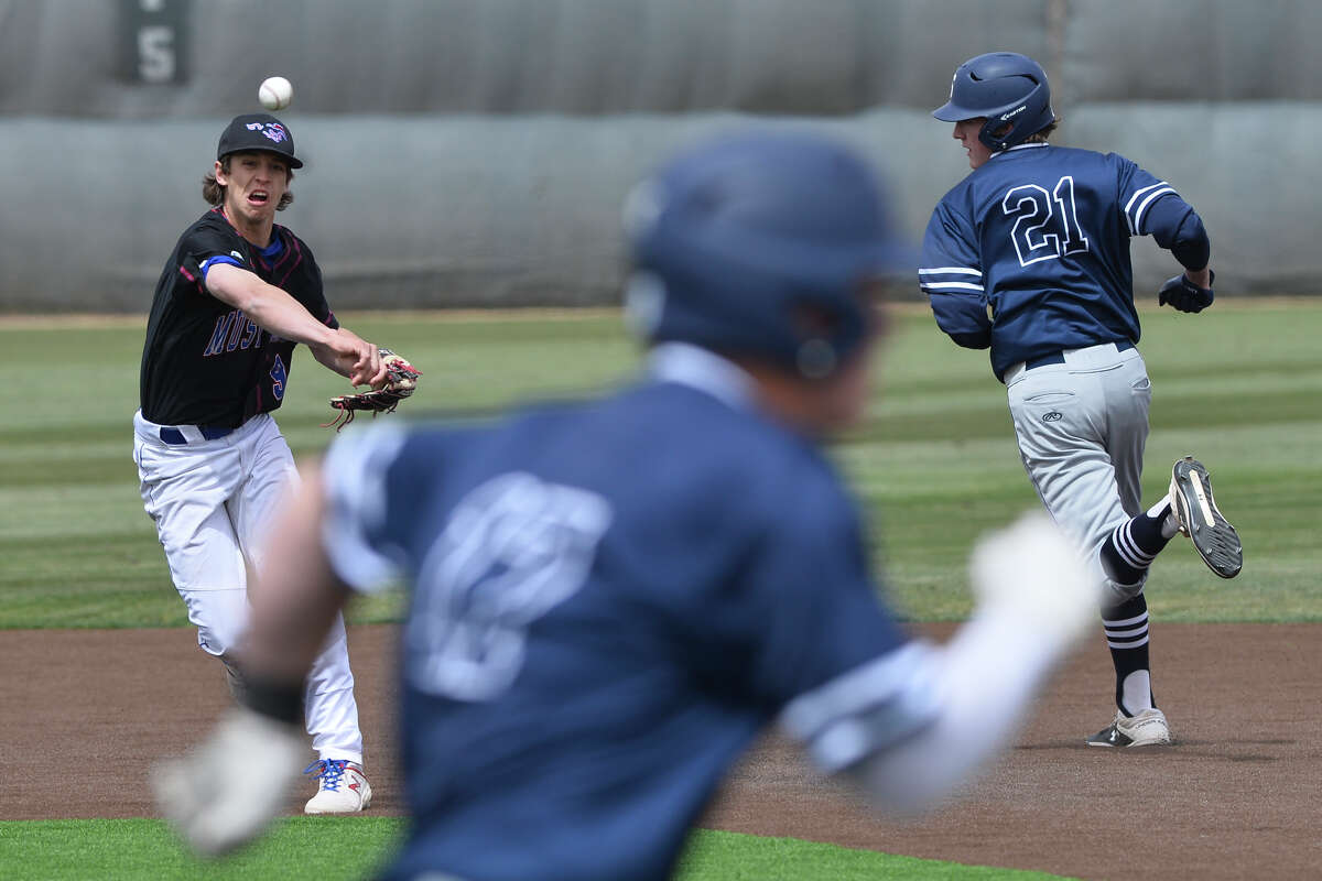 Midland Christian's Gage Jordan throws to first base after getting an out at second against Fort Worth All Saints' Jack Hardgrove (21) March 30, 2019, at Christensen Stadium. James Durbin / Reporter-Telegram