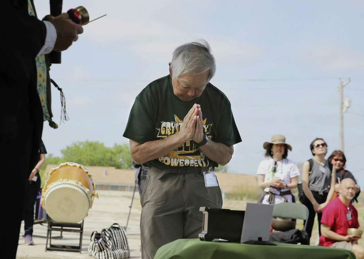 Joe Ozaki of Lakewood, Colorado bows in reverence during a memorial service near the former World War II internment camp in Crystal City on Saturday, Mar. 30, 2019. Ozaki was one of several internment survivors who attended a memorial in Crystal City and were interned there during World War II along with thousands of Japanese Americans and Japanese Peruvians. After the service, the internment survivors and about 100 people held a "Stop Repeating History" protest in Dilley, Tx., at the South Texas Family Residential Center where 1,000 Central American women and children are seeking asylum. The protest is to draw a parallel between the detention of Japanese American families during WW II and Central American asylum seekers. Taiko drums loudly echoed outside the detention facility as long chains of origami cranes were placed on the fencing outside the facility by the internment survivors and others protesting the detainments.(Kin Man Hui/San Antonio Express-News)