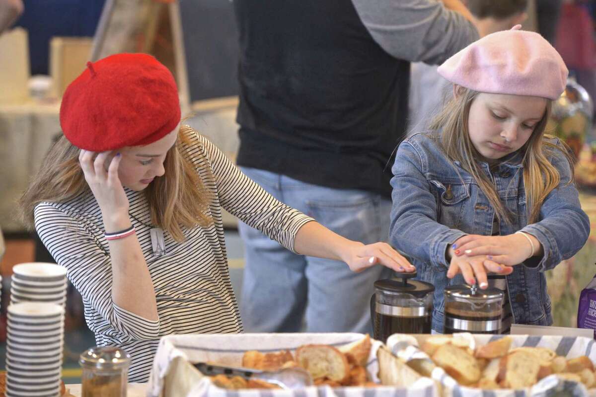 Mila Baker, left, and Sawyer Cutler, both 9, representing France, make french press coffee at the International Festival at Redding Elementary School on Saturday afternoon. March 30, 2019, in Redding, Conn. With the theme of "One Town, Many Stories" families shared foods and facts from their chosen nations.